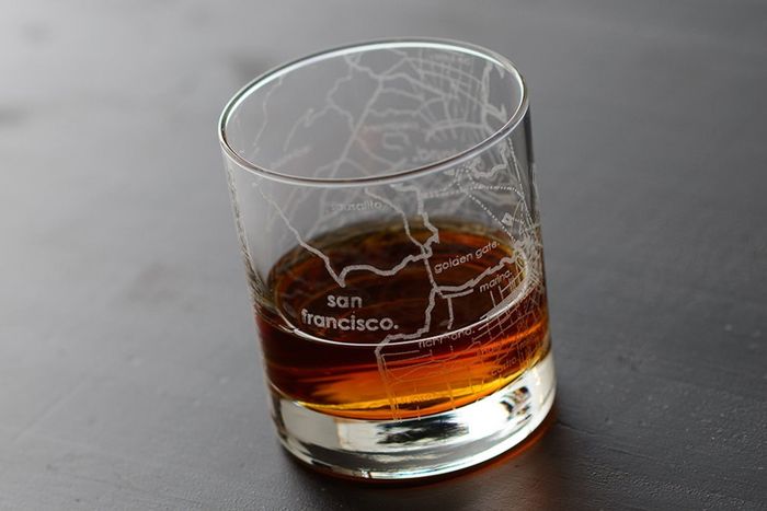 A clear whiskey glass featuring an engraved map of San Francisco.