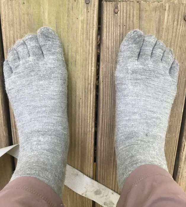 A person wearing light grey toe socks
