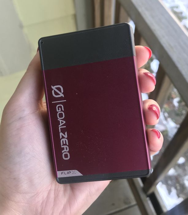 The writer holding a pink power bank