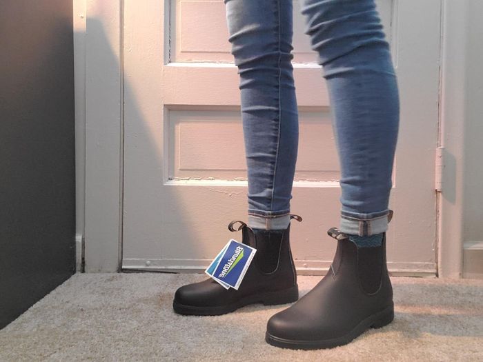 A model showcasing the boots in black