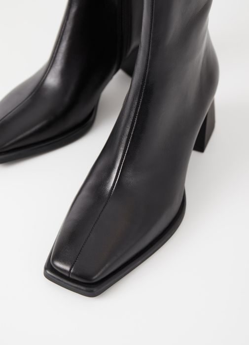 Close-up view of the black boots featuring the square toe design