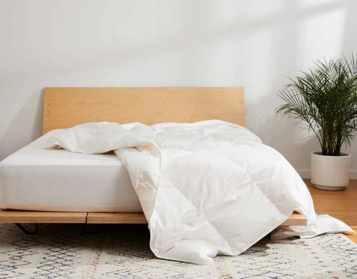 Brooklinen’s down comforter laid across a bed.