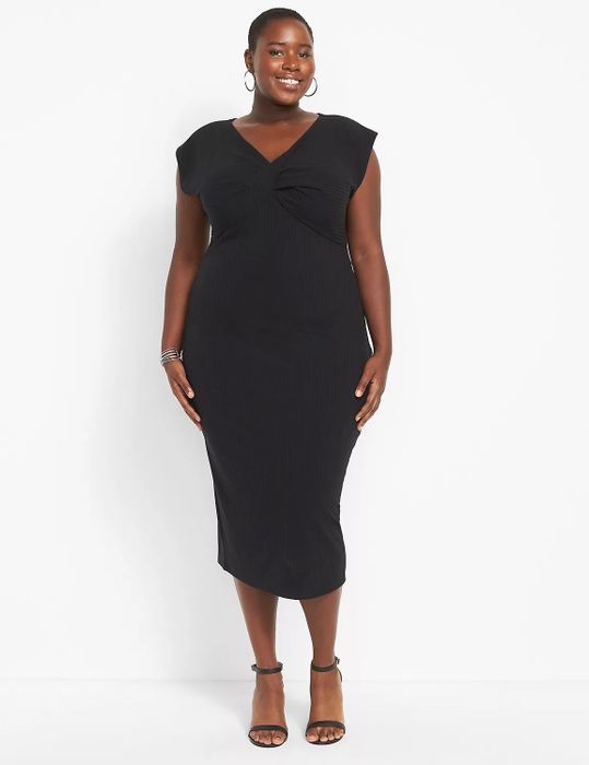 Model showcasing a black bodycon dress paired with black shoes