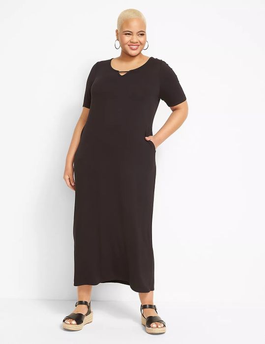 Model wearing a black dress paired with black sandals