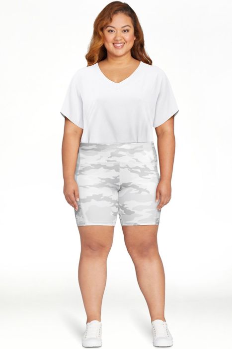 Model showcasing gray and white camo shorts.