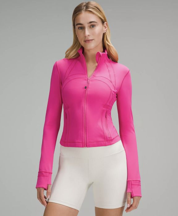 a model wearing the pink zip-up jacket
