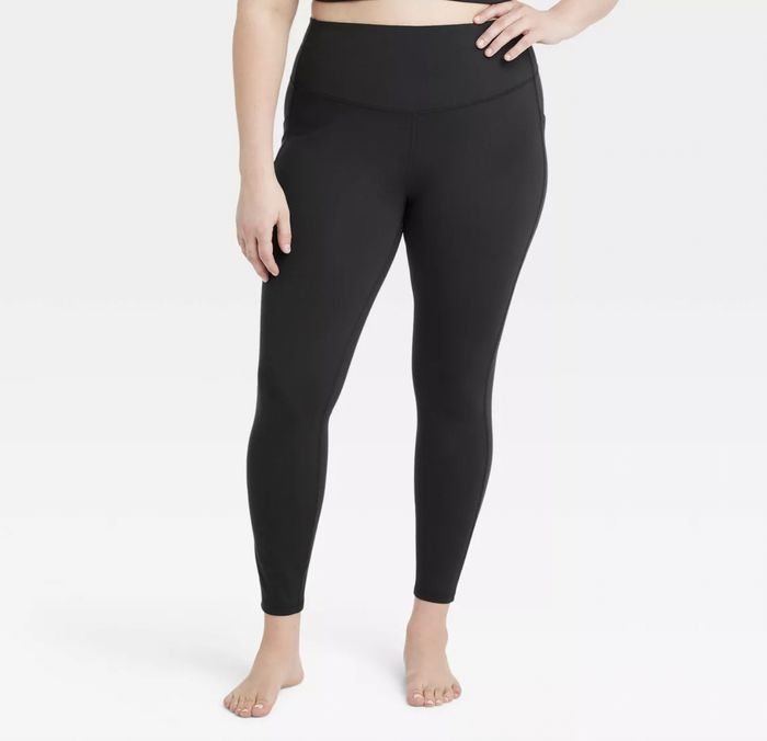 A person standing in plain leggings, with their hands not visible and upper body cropped out of the frame.