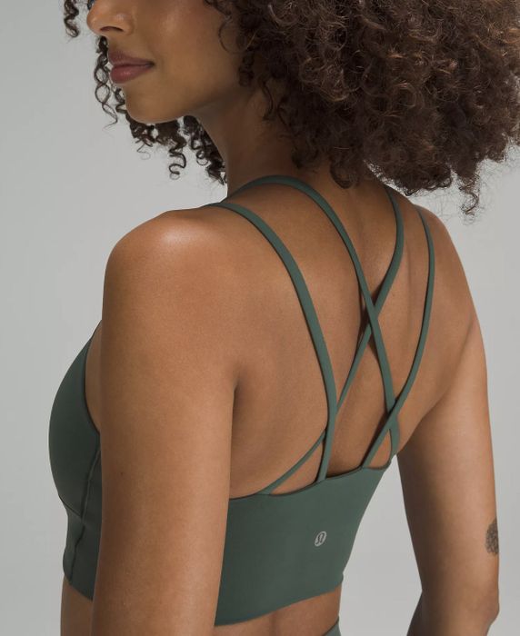 a close-up of a different model from the side, showcasing the criss-cross strappy back