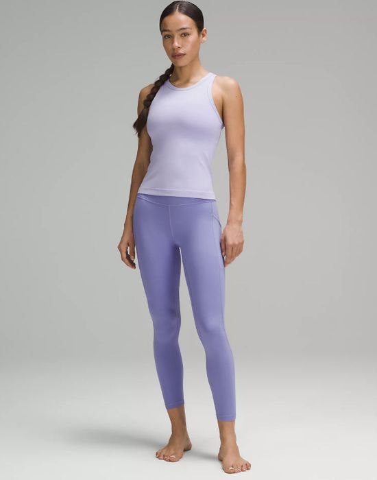 a model wearing the lilac leggings paired with a lighter purple top