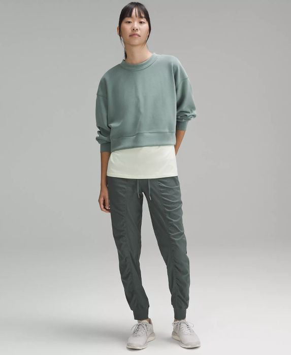 a model wearing green joggers paired with a cropped sweatshirt