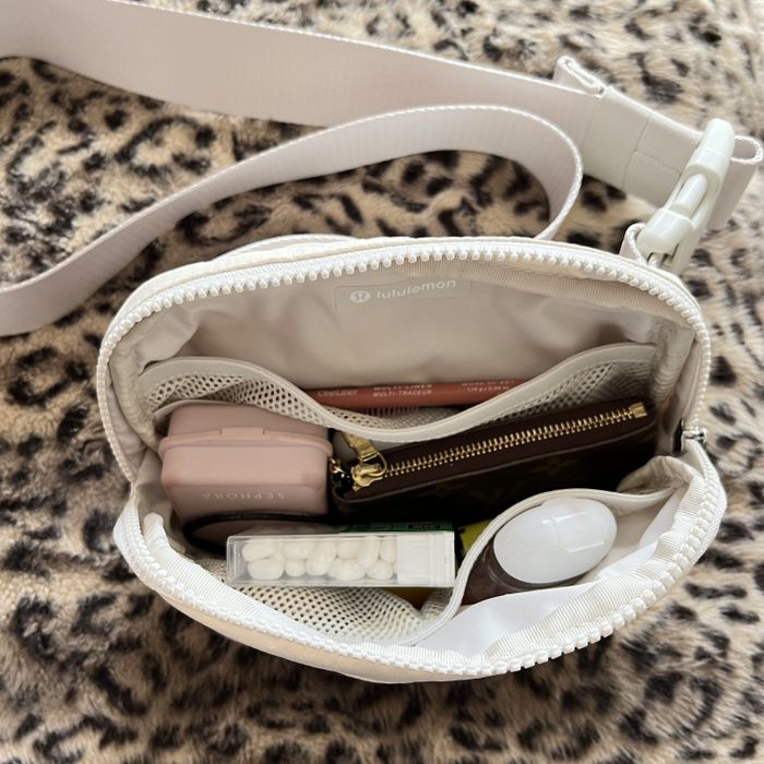 the belt bag open showing items inside