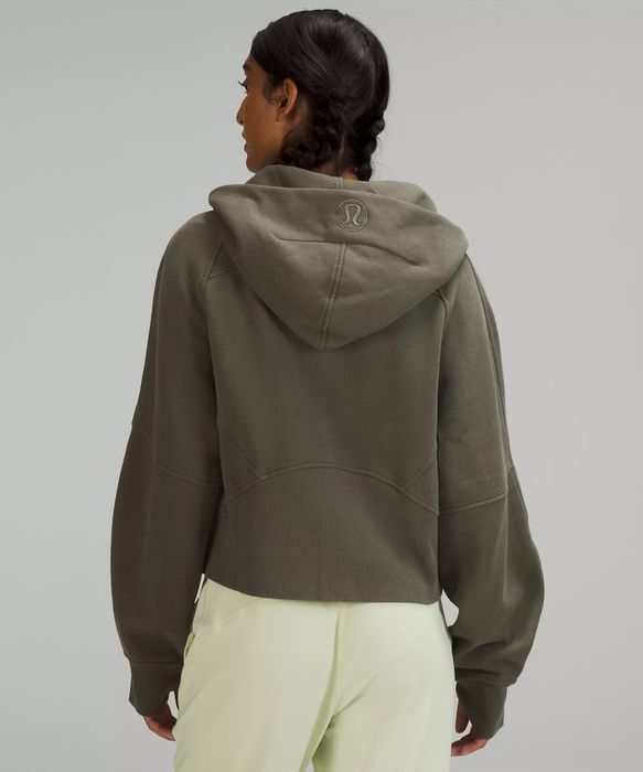 a model wearing a green hoodie