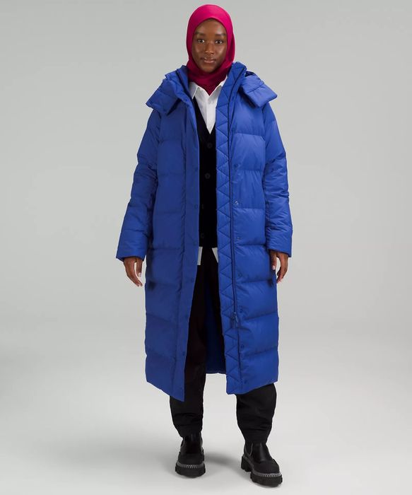 a model wearing a blue coat