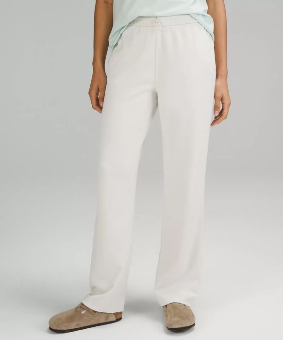 a model wearing white pants
