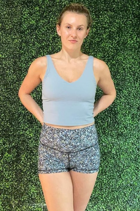 A reviewer wearing the sage green top.