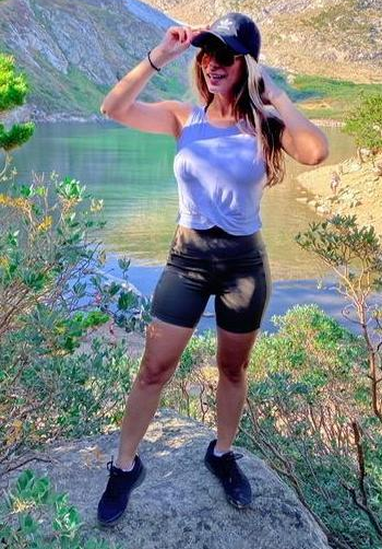 A reviewer wears the crop top in white paired with shorts.