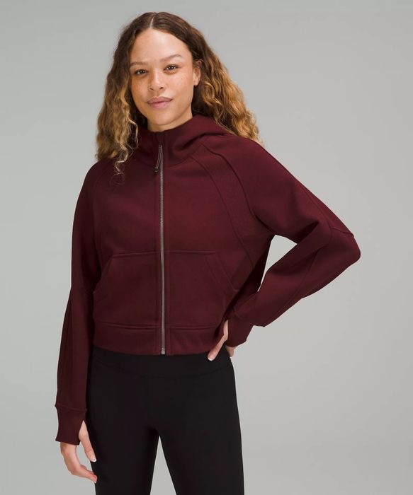 a model wearing a maroon hoodie