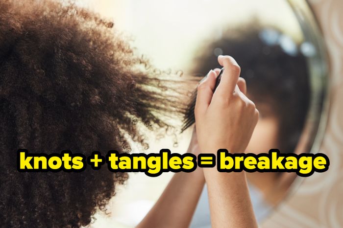 someone running a pick through their curls
