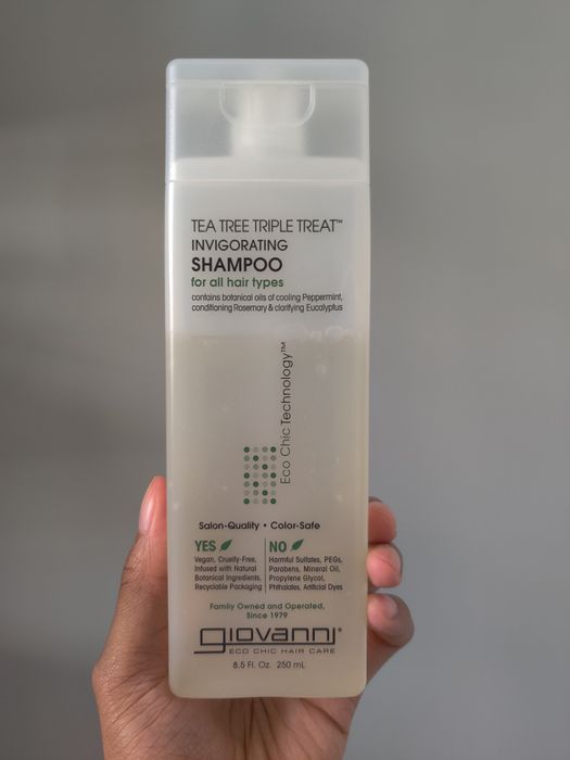 hand holding the shampoo bottle