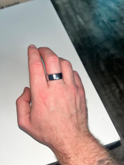 A reviewer's hand adorned with the Oura ring