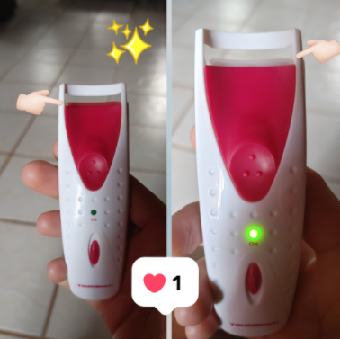 reviewer demonstrating the use of a heated eyelash curler