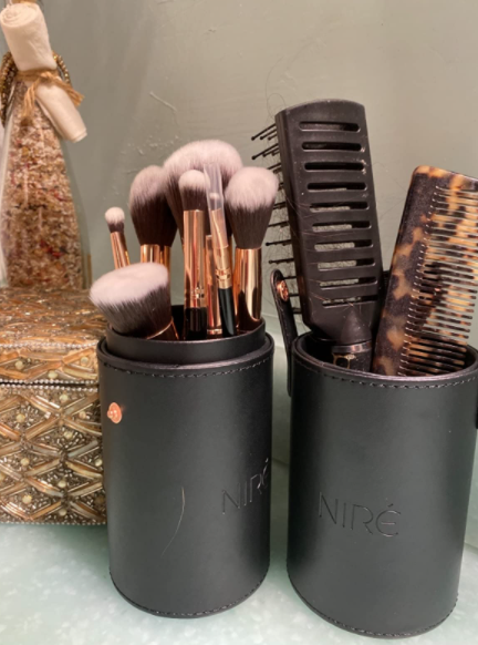 An image of a reviewer displaying the makeup brush set
