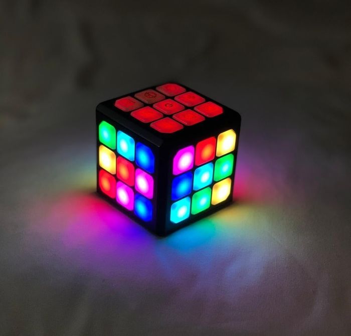 An illuminated LED color cube glowing vibrantly.