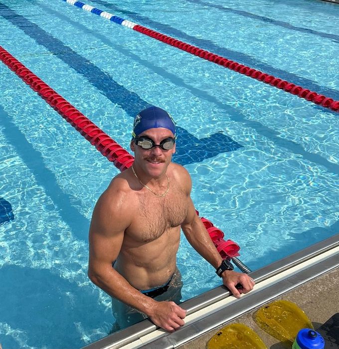A reviewer wearing smart swim goggles