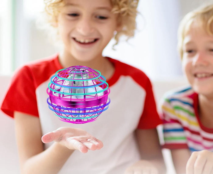 A child playing with a floating ball