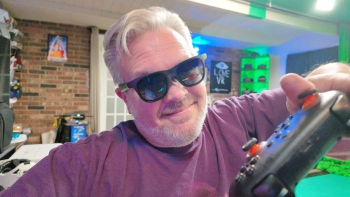 A reviewer showcasing the AR sunglasses they're wearing