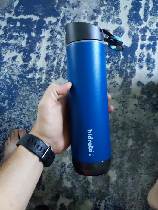 A reviewer holding a water bottle
