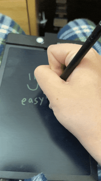 A hand holding a pen and writing