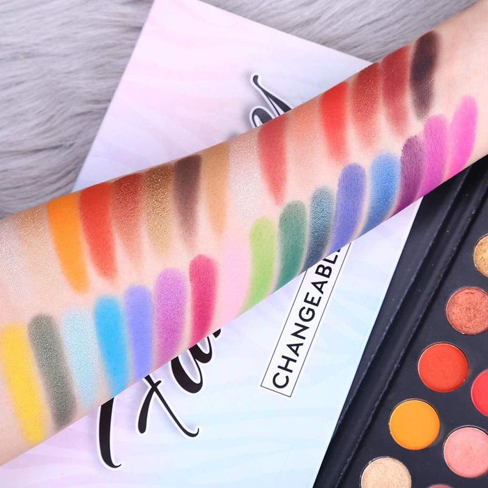 A model showcasing the eyeshadow palette swatched on their arm.