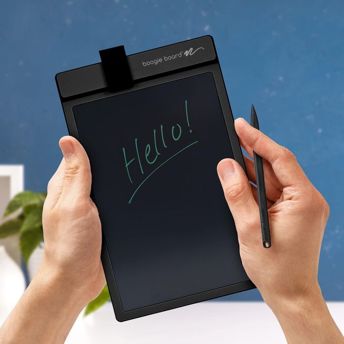 An individual holding a Boogie Board writing tablet