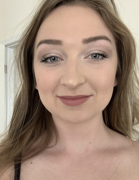 reviewer modeling a lipstick look