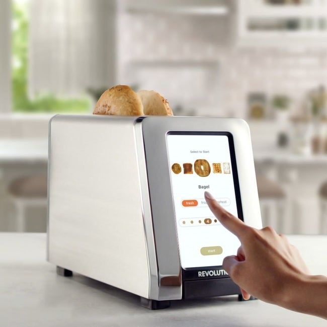 A model interacting with the touchscreen of the Revolution toaster.