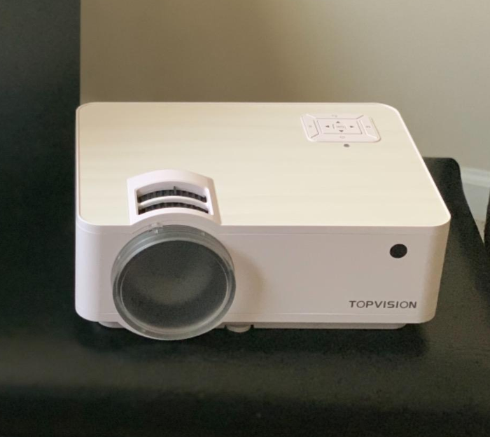 a reviewer's photo of the compact white projector