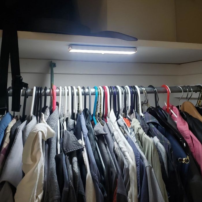 a reviewer photo of a closet showcasing one of the lights installed beneath the shelf