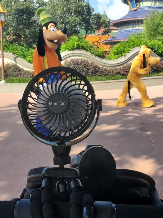 a reviewer's black fan attached to a stroller
