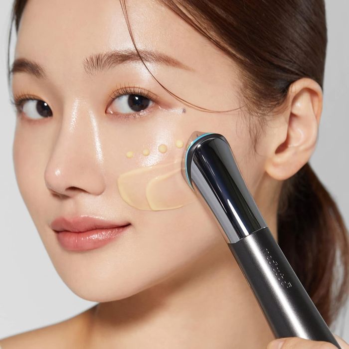 The model applying skincare products using the device