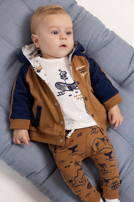a baby wearing a vibrant orange jacket with contrasting blue highlights
