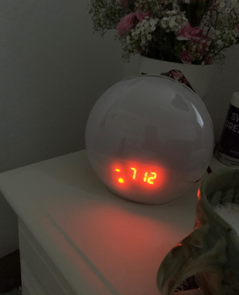 A circular alarm clock displaying the current time