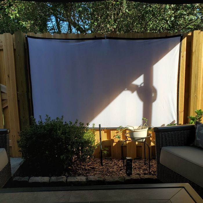 a reviewer's image of the projection screen set up in a backyard, ready for outdoor movie nights