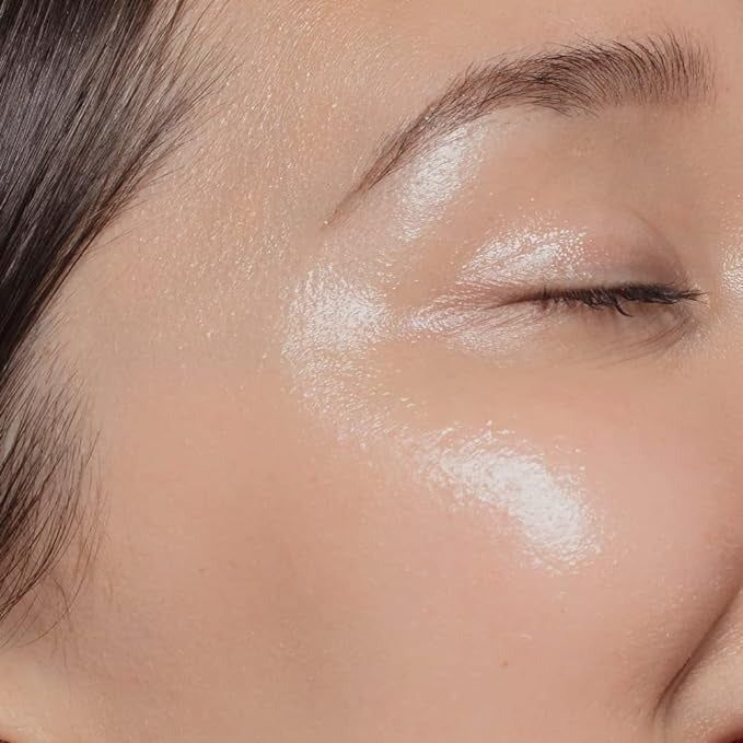 Close-up of a cheekbone with shimmering highlighter makeup