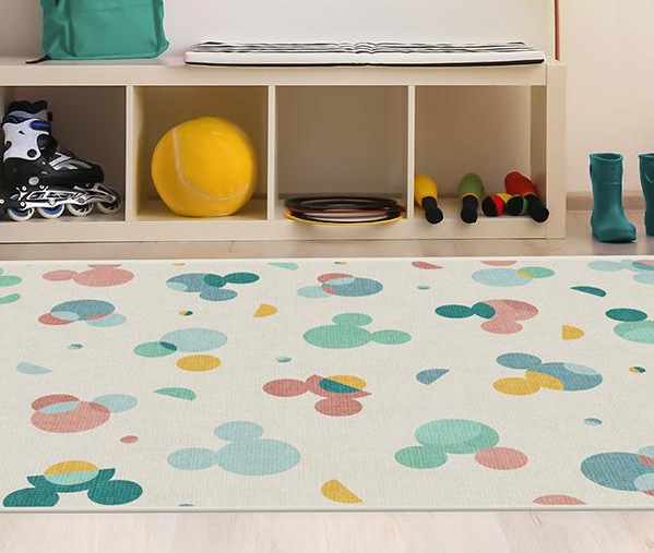 A colorful Mickey Mouse-themed rug, perfect for brightening up your nursery while being easy to clean when messes happen.