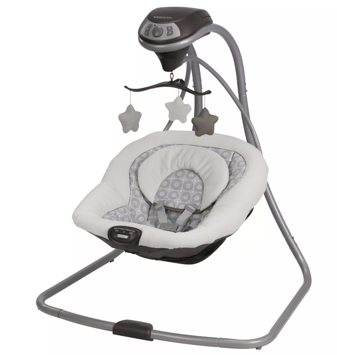 a gray swing with a starry mobile hanging above it