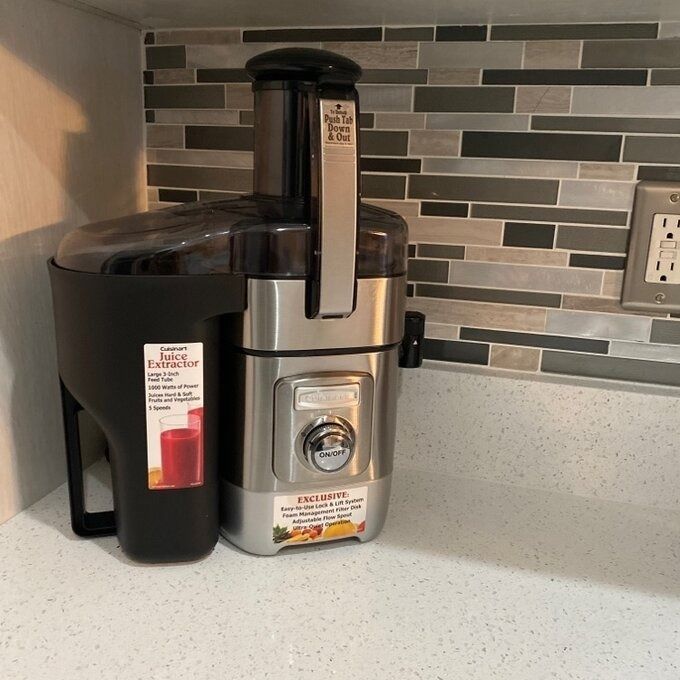 The juice extractor sitting on a kitchen counter