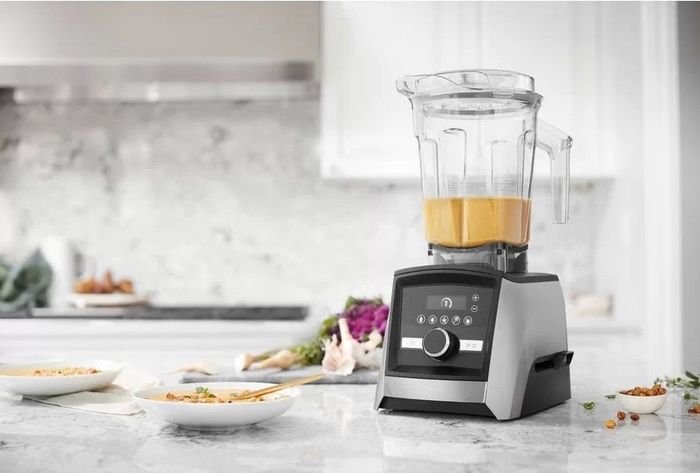 The Vitamix blender preparing soup on a kitchen counter