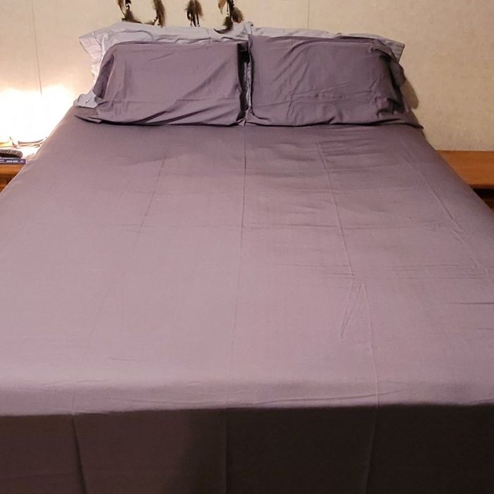 a reviewer photo of a bed with purple bed sheets