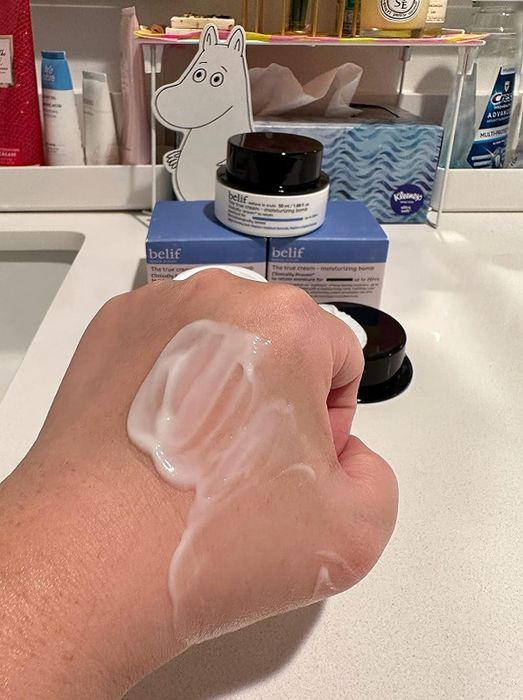 Reviewer's hand showcasing the cream